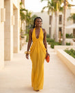 Mustard Yellow Gleam Evening Halter Maxi Dress Mustard Yellow Maxi Dress with Relaxed Fit silhouette and Textured texture, lifestyle scene image for Resort Wear, a polished coastal brunch, US East / Hamptons Elite by floravincie