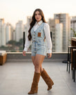 Light Wash Denim Eyelet V-Neck Jacket "Sabine" Light Wash Denim Jacket with Cropped silhouette and Textured texture, outdoor styling image for Travel Layer, a gallery opening in Paris, Euro Chic Premium