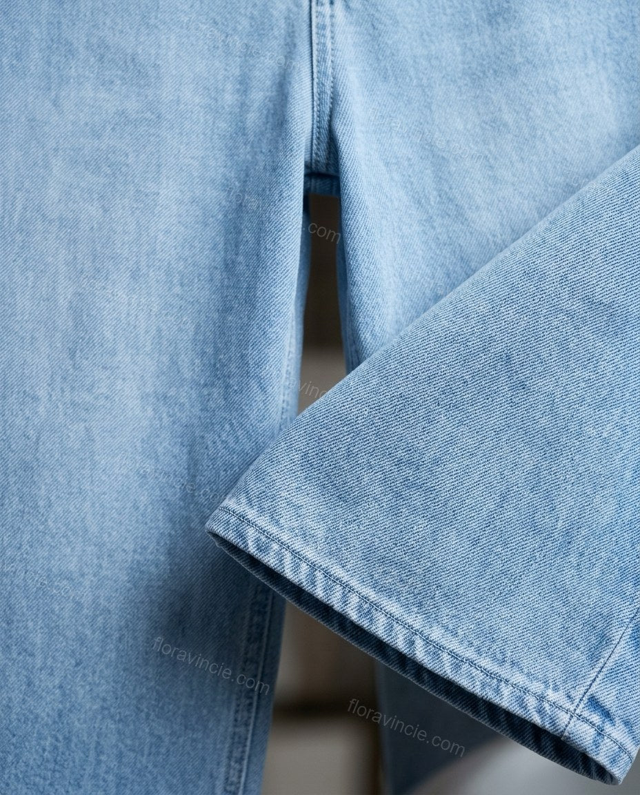 Light Blue Denim Jumpsuit, close-up of white accents, collared neckline and front button closure, by Floravincie