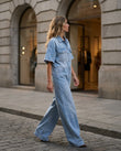 Light Blue Denim Jumpsuit, three-quarter brand lifestyle view, by Floravincie