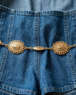Blue Mini Denim Lace Jumpsuit, close-up of deep v-neck, cutout at neckline and thin shoulder straps, by Floravincie