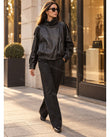 Black Asymmetric Jacket, three-quarter brand lifestyle view, by Floravincie