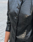 Black Peplum Jacket, close-up of button closure, crocodile embossed texture and cropped length, by Floravincie