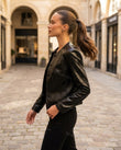 Black Peplum Jacket, walking lifestyle view, by Floravincie